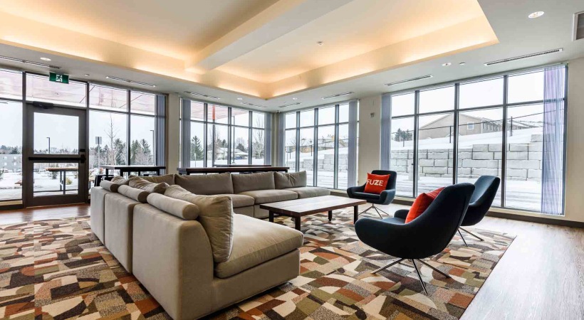 a large  room with a large white couch and a media area