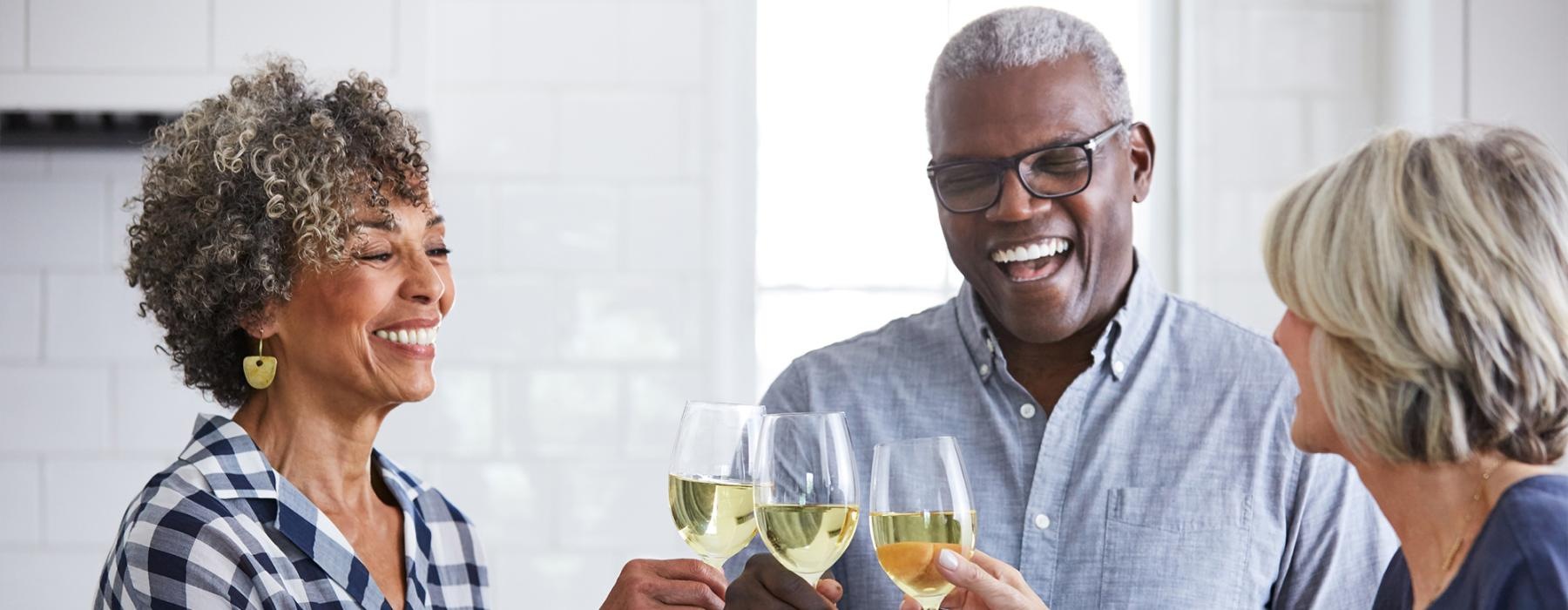 a few people toasting wine glasses